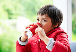 Young children drinking soda from a can