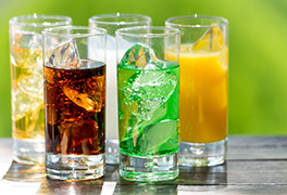 Glasses of different sodas and sugary drinks